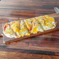 Margherita Pizza · Thin crust, olive oil, garlic, basil, tomato, mozzarella cheese.