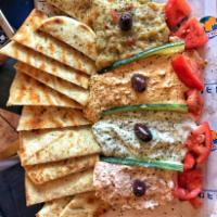 Dip & Spread Sampler · Sampler of all our signature spreads, served with 4 toasted pita breads.