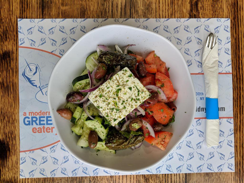Greek Salad · Greek imported Feta, olives, stuffed grape leaves, vine ripened tomato, cucumber, onions and romaine lettuce. Served with our house dressing on the side.