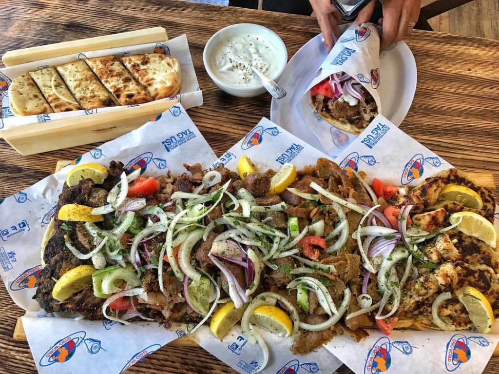 The Gyro World Plate · OUR FAMOUS MIXED GRILL GW PLATE! An awesome assortment of all our signature meats. Beef & Lamb Gyro, Chicken Gyro, Bifteki, Chicken Bifteki, Pork Souvlaki, & Chicken Souvlaki. Small served with 4 pitas and Tzatziki sauce. Large served with double of everything from the small. NO SUBSTITUTIONS.