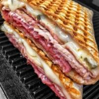 9. Monte Cristo Panini · Layers of ham and smoked turkey, Swiss and cheddar cheese, lettuce and honey mustard. Served...