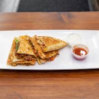 2. Steak Quesadilla · Grilled prime roast beef with cheddar and jack cheeses, salsa and sour cream.