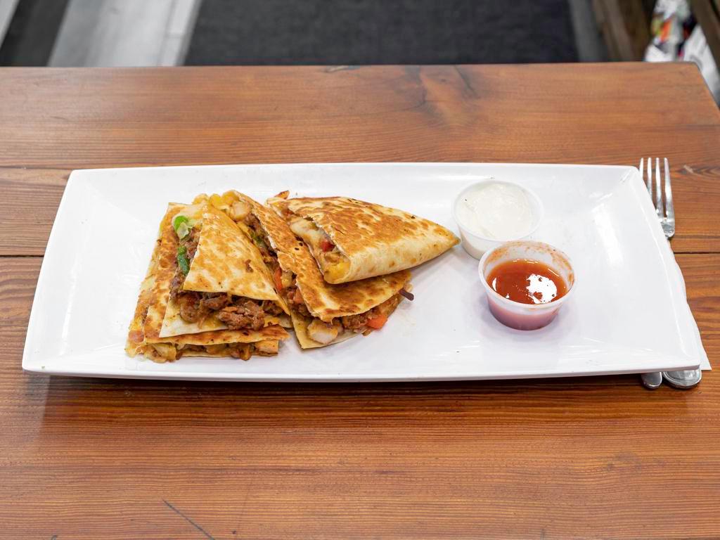 2. Steak Quesadilla · Grilled prime roast beef with cheddar and jack cheeses, salsa and sour cream.