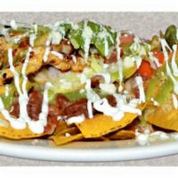 Nachos · Fried chips with cheese, beans, guacamole, tomatoes sour cream lettuce and jalapenos.