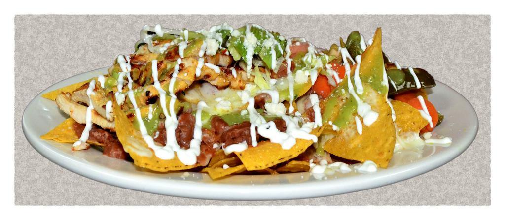 Nachos · Fried chips with cheese, beans, guacamole, tomatoes sour cream lettuce and jalapenos.
