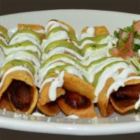 Tacos Dorados · 4 tacos. Chicken only. Served with rice and beans. Topped with sour cream, lettuce and hot s...