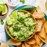 Vegan Guacamole & Chips · Avocado, onion, tomato, cilantro, radish, lime with a basket of corn tortillas chips.
