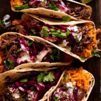Barbacoa Taco (1pc) · Mexican slow cook braised beef, cabbage, lettuce, pico de gallo, salsa verde on a corn masa ...