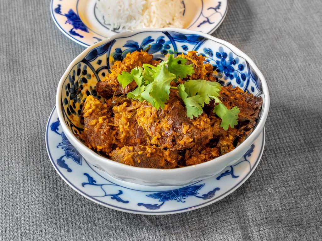 Beef Rendang · Braised Beef in Malaysian curry, sauteed and topped with toasted coconut. Comes with side of white rice