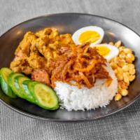 Nasi Lemak · Traditional Malaysian dish consisting of curried chicken, served alongside rice topped with ...