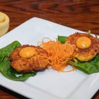 Crab Cake · Two pan seared lump meat cake over greens.