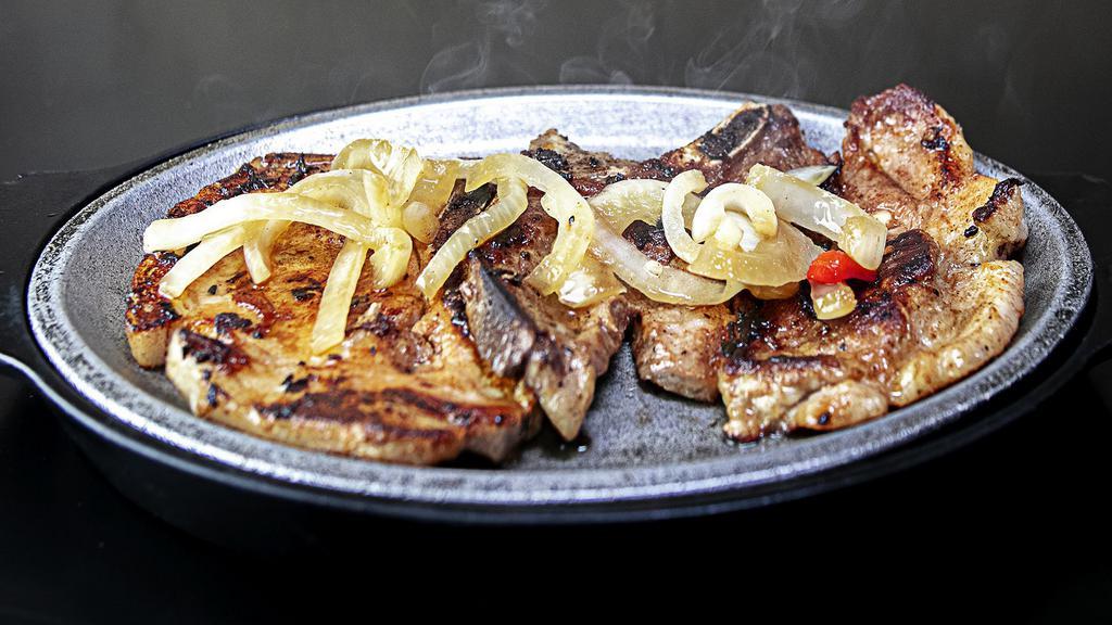 Chuletas a la Plancha - Grilled Pork Chops · Grilled Pork Chops. Served With 2 Sides