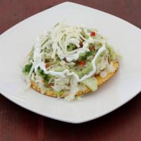 Veggie Tostadas · Crispy flat corn tortilla with beans, lettuce, tomatoes, cheese, guacamole and sour cream.