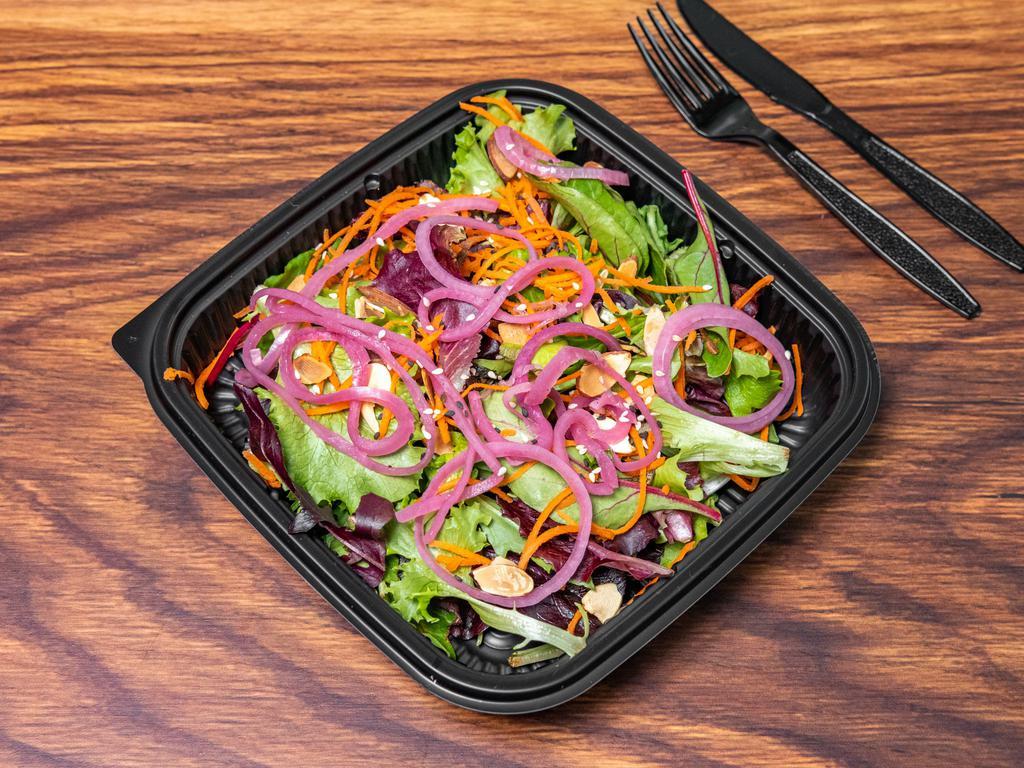 Nutty Salad · Mix greens, carrots, roasted almonds, pickled onions and sesame seeds. Served with a sesame soy glazed dressing.