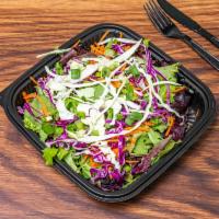 Slaw Salad · Mix greens, red and green cabbage, carrots, sesame sticks, green onions. Served with a balsa...