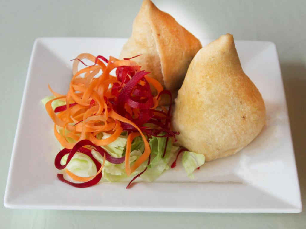 Vegetable Samosa · Pastries stuffed with potato, green peas and spices.