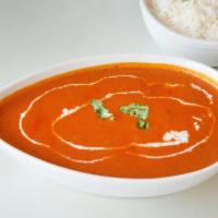 Chicken Tikka Masala · Skewered chicken cooked in a creamy tomato fenugreek sauce. Prepared with white meat and ser...