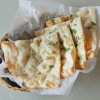 Garlic Naan · White flour bread cooked in tandoor.
