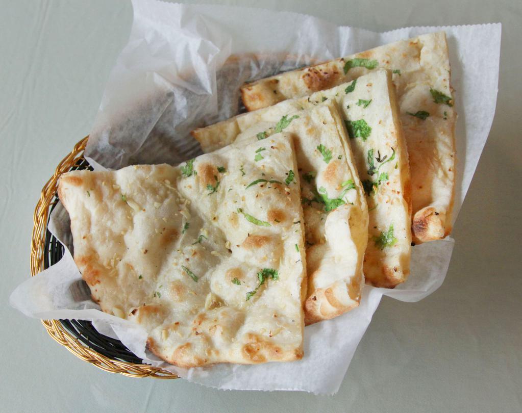 Garlic Naan · White flour bread cooked in tandoor.