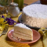 White Coconut Cake · This palette-pleasing cake features two layers of light, buttery white cake. It is covered a...