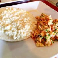 Huevos Pericos, con Arepa y Queso · Colombian style eggs-scrambled eggs with corn cake and cheese.