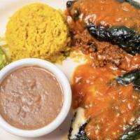 Chiles Rellenos · 2 Roasted Poblano Peppers, 1 Filled With Monterey Jack Cheese And 1 With Ground Beef Topped ...