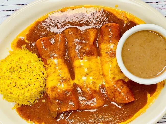 Las Reynas Beef Fajita · Three Beef Fajita Enchiladas Topped With Melted Cheese And Beef Gravy. Served With Rice & Refried Beans