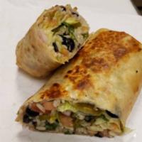 Vegetarian Burrito · Served with black beans, seasoned rice onions, tomato, and cilantro. Vegan.