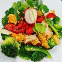 E4. Trio Salmon · Deep fried salmon stir fried with carrot, zucchini red and green bell peppers, broccoli, bok...
