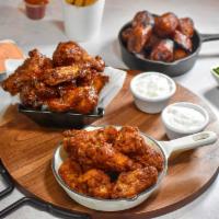 Chicken Wings  · Cooked wing of a chicken coated in sauce or seasoning.