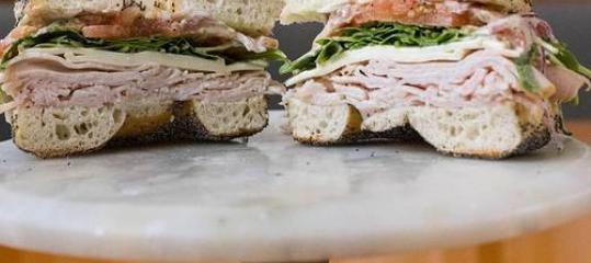 Turkey and Arugula · Sliced turkey, swiss cheese, tomato, arugula, red onion, and pesto mayo. If your bagel selection is not available, we will substitute for something close!