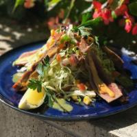 The Southwestern Ensalada · Seared rare ahi tuna served over mixed greens with roasted corn and chipotle sauce, tossed i...