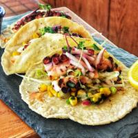 Pulpo Taco · Grilled octopus, sauteed corn, pico de gallo, white corn tortillas and salsa charra.