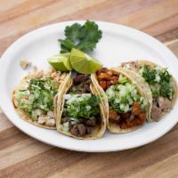 Street Taco · Served with choice of meat. Includes 4 soft tacos garnished with cilantro, onions and lime.