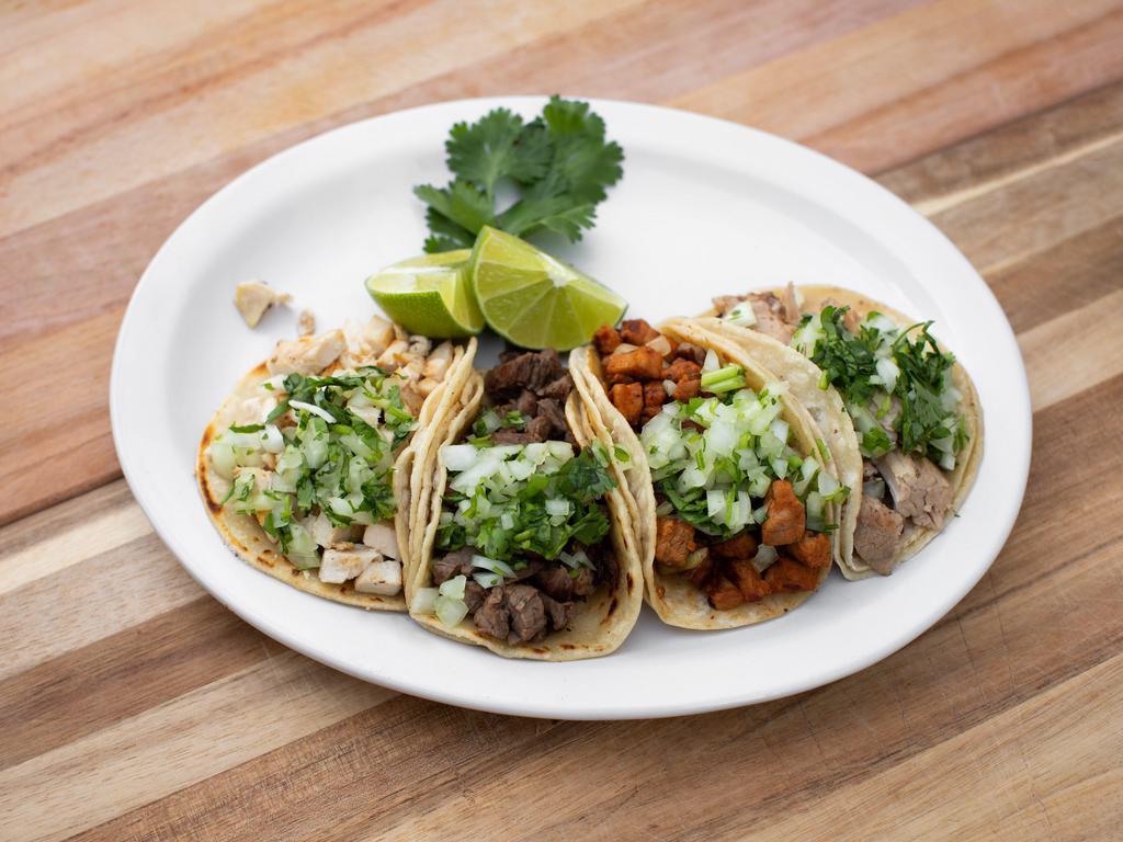 Street Taco · Served with choice of meat. Includes 4 soft tacos garnished with cilantro, onions and lime.