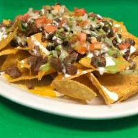 Super Nachos · A bed of tortillas chips topped with refried beans, mozzarella cheese, meat of your choice g...