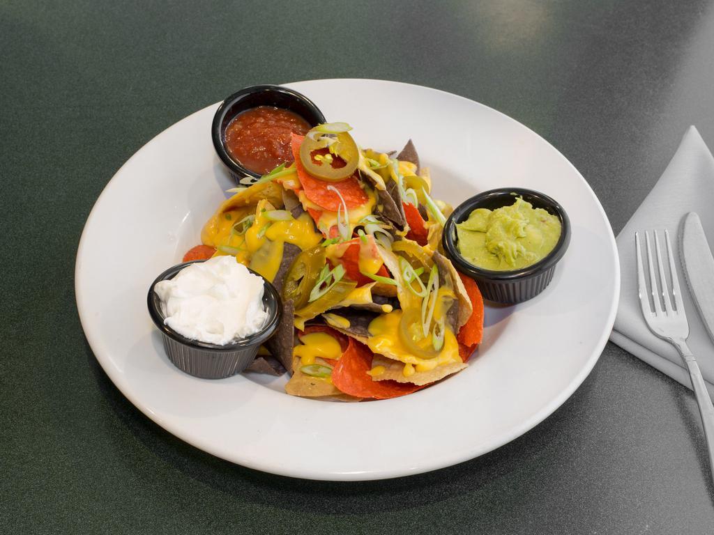 Nachos · Warm corn tortilla chips topped with cheese sauce, green scallions and jalapenos served with salsa, guacamole and sour cream. Add chicken and chili for an additional charge.