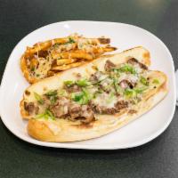Steak Sandwich · Sliced steak and caramelized onions topped with Swiss and pepper jack cheese served with Par...