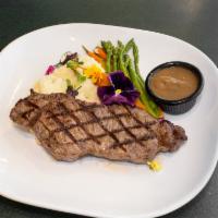 Grilled New York Strip Steak · Served au poivre style with mashed potatoes, carrots and asparagus. Served with a side salad.