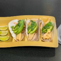 Fish Tacos · Tempura battered fish, coleslaw, avocado, cilantro and tartar sauce served on flour tortillas.