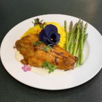 Sweet and Spicy Catfish · Filet of catfish seared with blackening spice and brown sugar, served with yellow rice, saut...