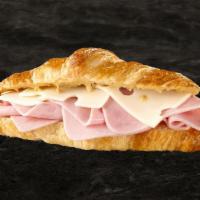 Le Pari Prensada · Boar’s Head® Deluxe Ham, Imported Switzerland Swiss®, and Vermont Cheddar on a croissant.