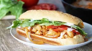The Buffalo Chicken Sub · Crispy breaded chicken cutlet coated in Buffalo sauce topped with blue cheese on a hoagie ro...