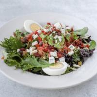 Cobb Salad · Fresh greens topped with chicken, diced tomatoes, hard boiled eggs, blue cheese, bacon and a...