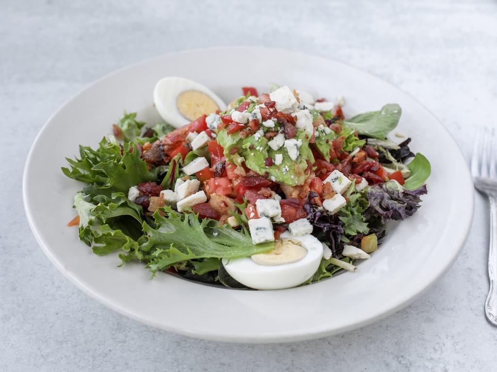 Cobb Salad · Fresh greens topped with chicken, diced tomatoes, hard boiled eggs, blue cheese, bacon and avocado.