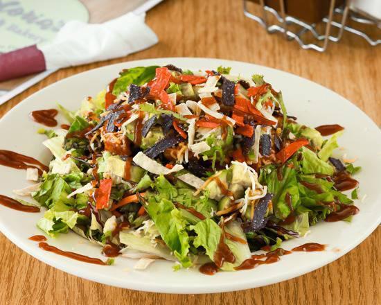 BBQ Chicken Salad · Fresh greens topped with diced chicken, tortilla strips, corn, black beans, onions, cilantro and avocado, drizzled with BBQ sauce.
