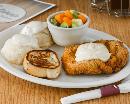 Chicken Fried Steak · An 8 oz. tender steak breaded and deep-fried to a golden brown, topped with country gravy and served with mashed potatoes, vegetables, and garlic bread.