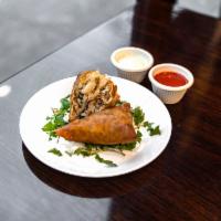 Chicken Samosas · Homemade pastry stuffed with chopped chicken, carrots and peas.