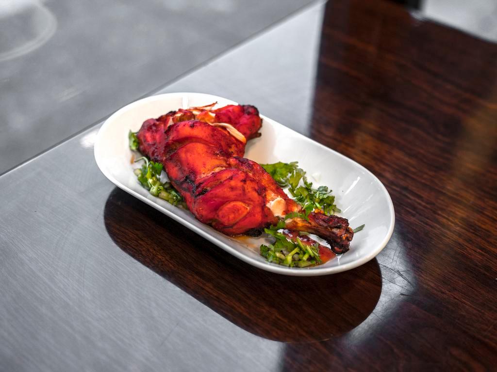 Tandoori Chicken · Two pieses of chicken leg marinated with yogurt, ginger, garlic and mild spices. Comes with either rice or naan.