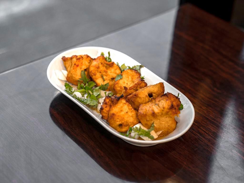 Chicken Tikka Five Pieces BONELESS · Boneless chicken breast marinated with tikka masala, lime juices and mild spices. Comes with a option of rice or naan.